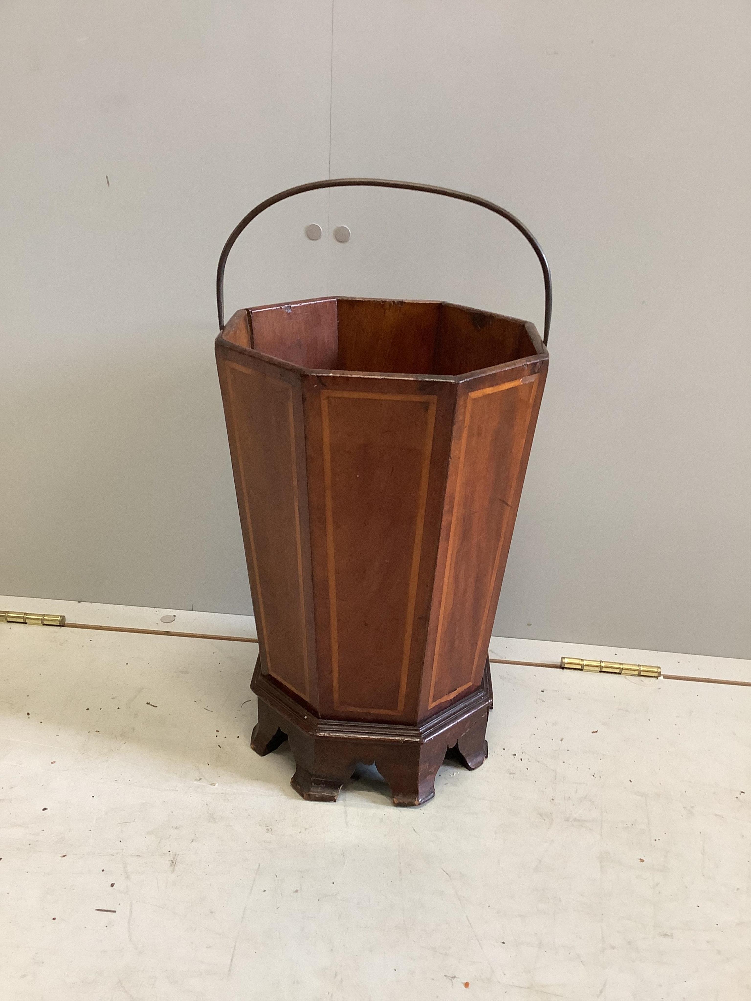 A 19th century octagonal inlaid mahogany waste paper bin, raised on bracket supports, width 26cm, height 40cm